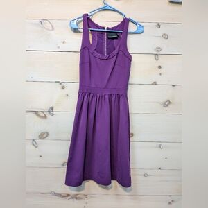 Purple fitted dress.
